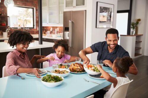 Family with children eating a home-cooked meal