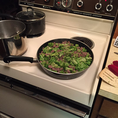 buffalo and broccoli in frying pan