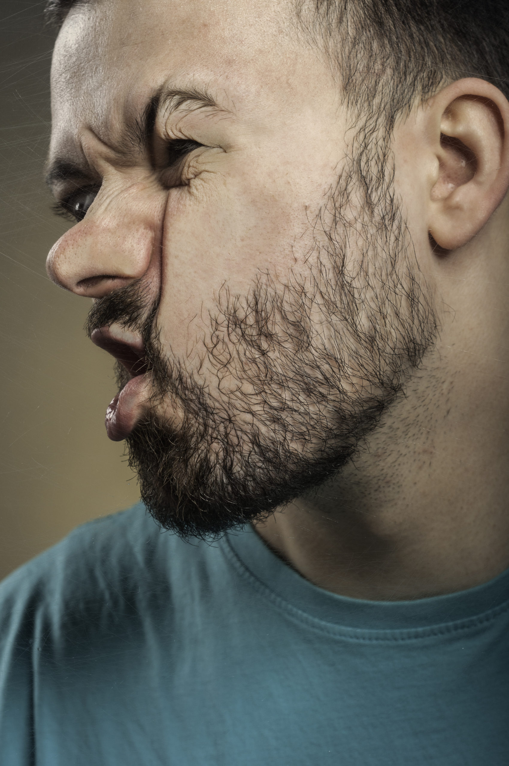 Man with face smashed against glass