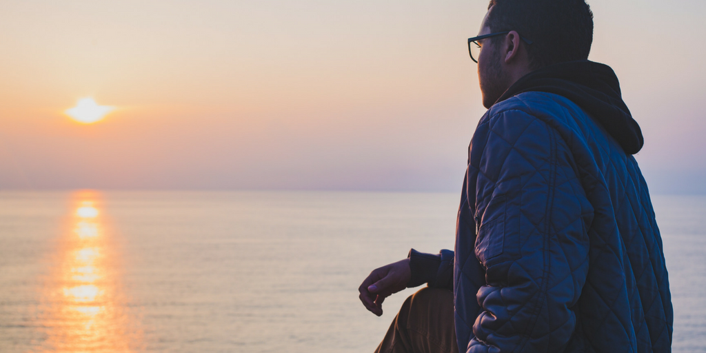 man looking at sunset